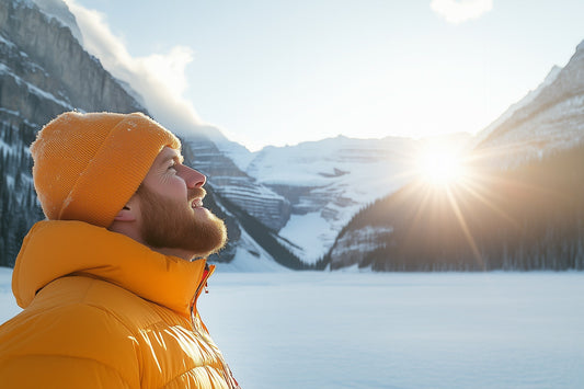 Bearded man in a Canadian landscape mountains with the sun setting in the distance