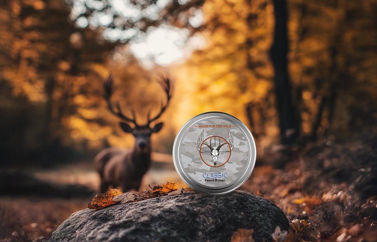 Beard Butter on a rock in a forest with a deer in the background on a fall day